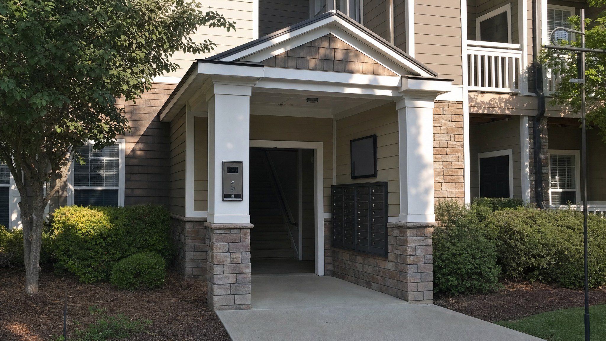 Apartment building entrance with intercom and mailboxes