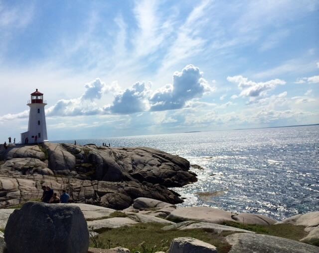 Lighthouse on a rocky shoreline overlooking the ocean
