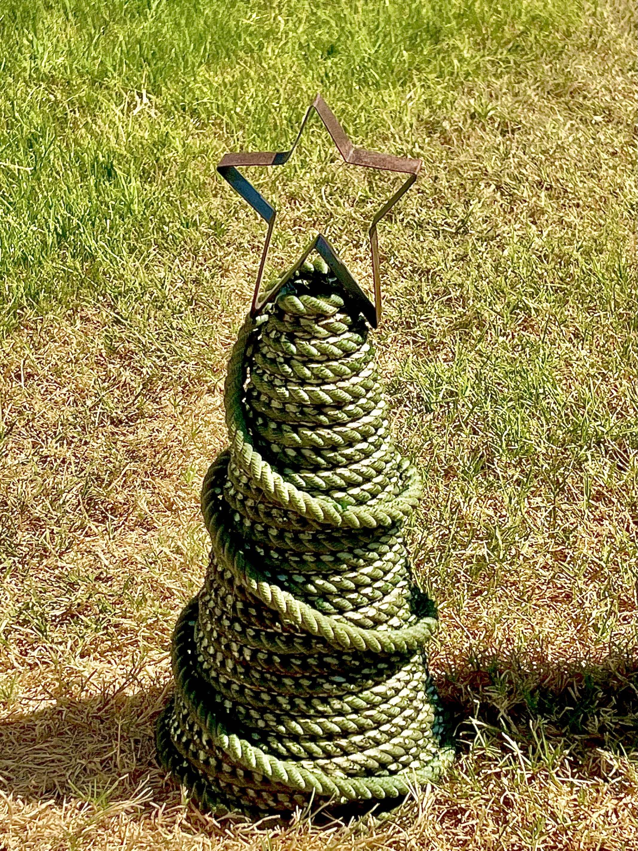 Handmade green rope piece topped with an open metal star