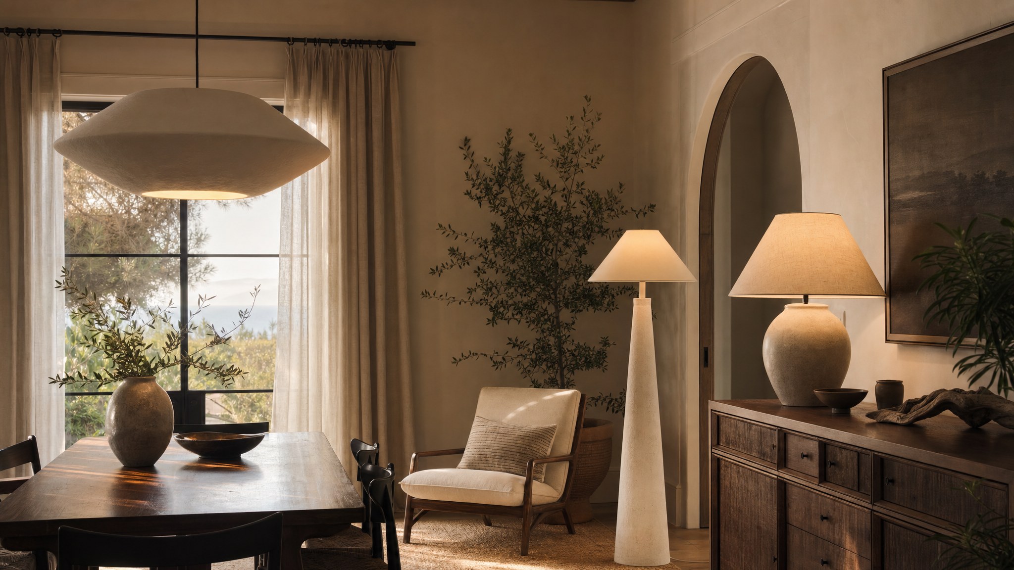 A warm residential room layered with pendant, table, and floor lighting