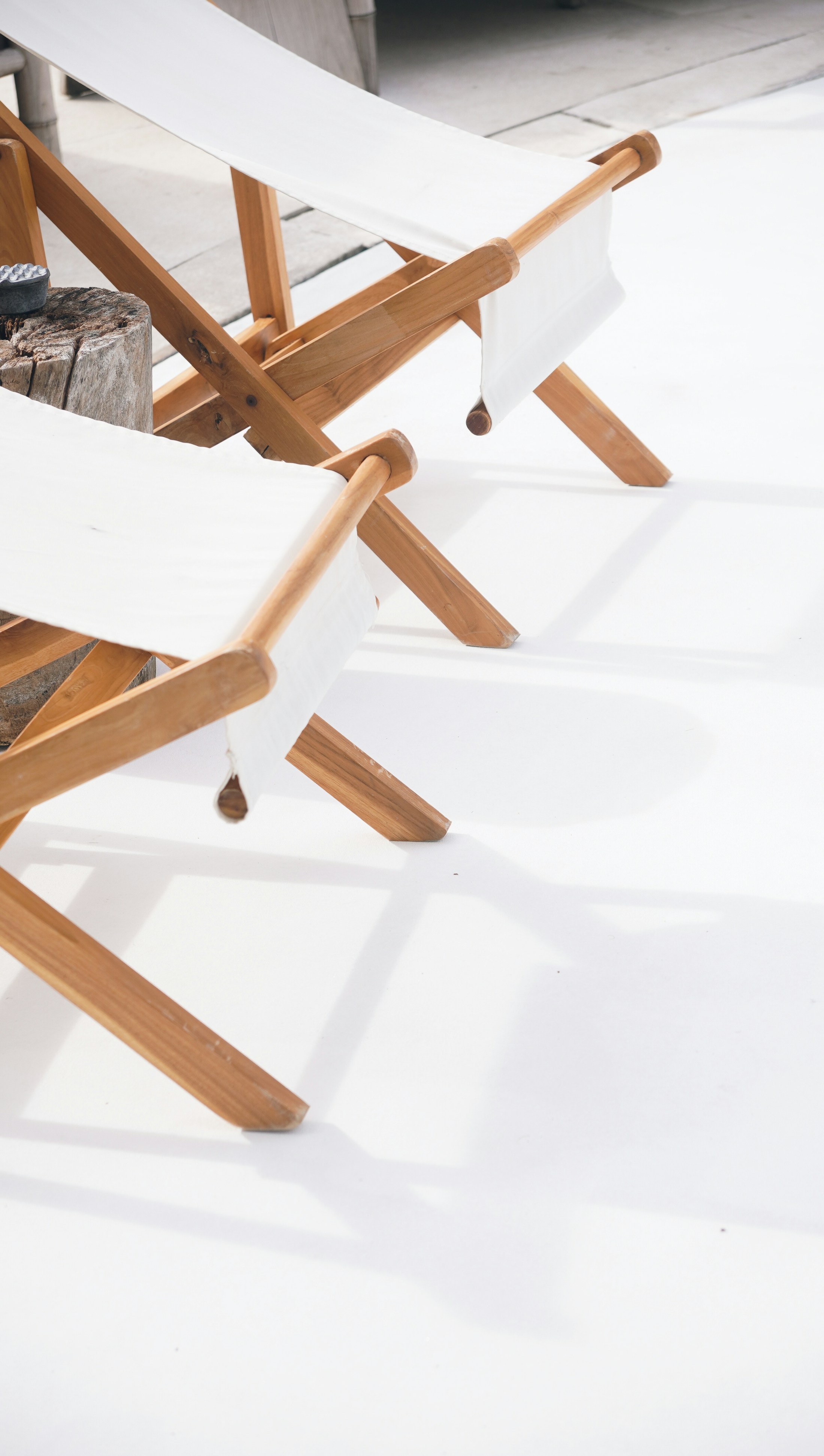 Teak outdoor chairs in bright daylight