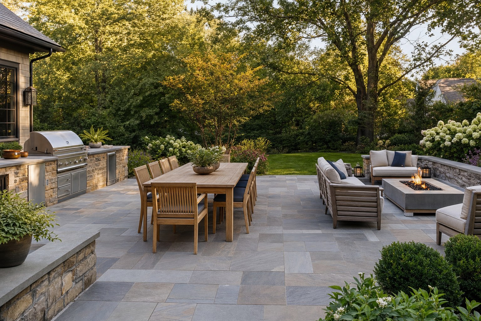 Backyard patio arranged with separate grilling, dining, and fire-table lounge areas