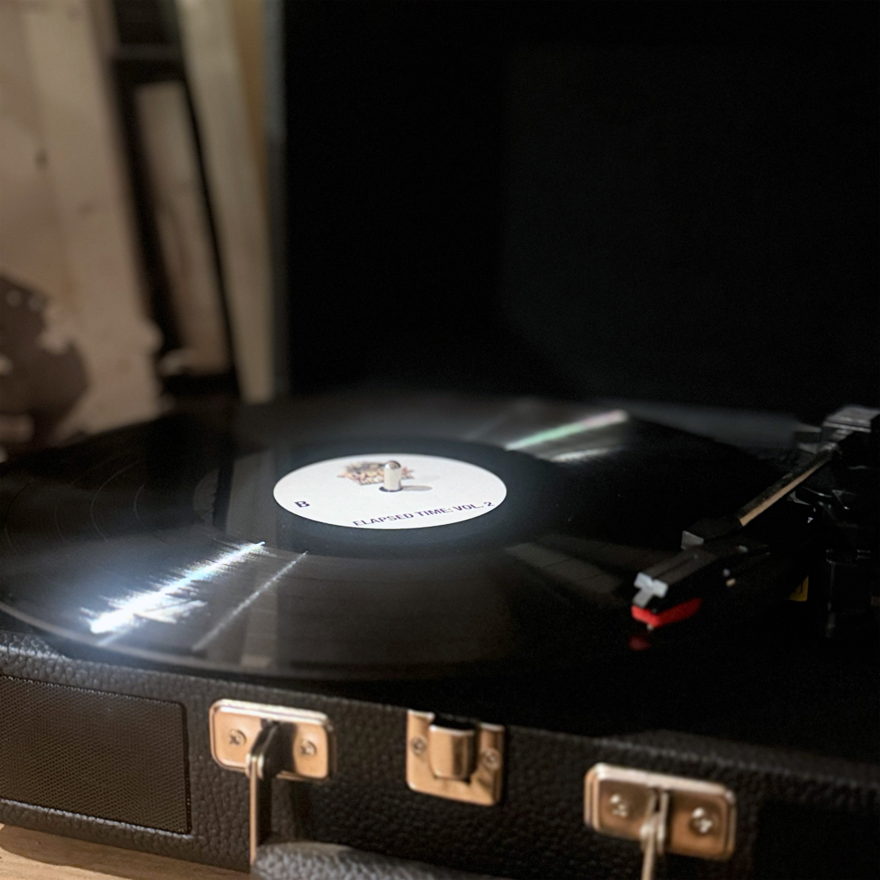 Elapsed Time Vol. 2 vinyl record playing on a portable turntable