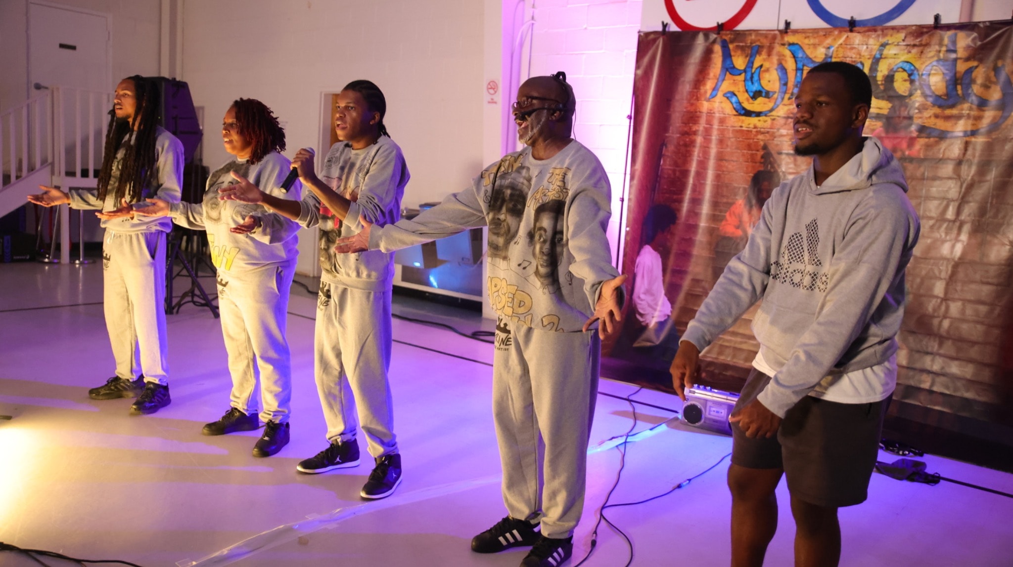 Tyrine the Artist and performers onstage during a live show