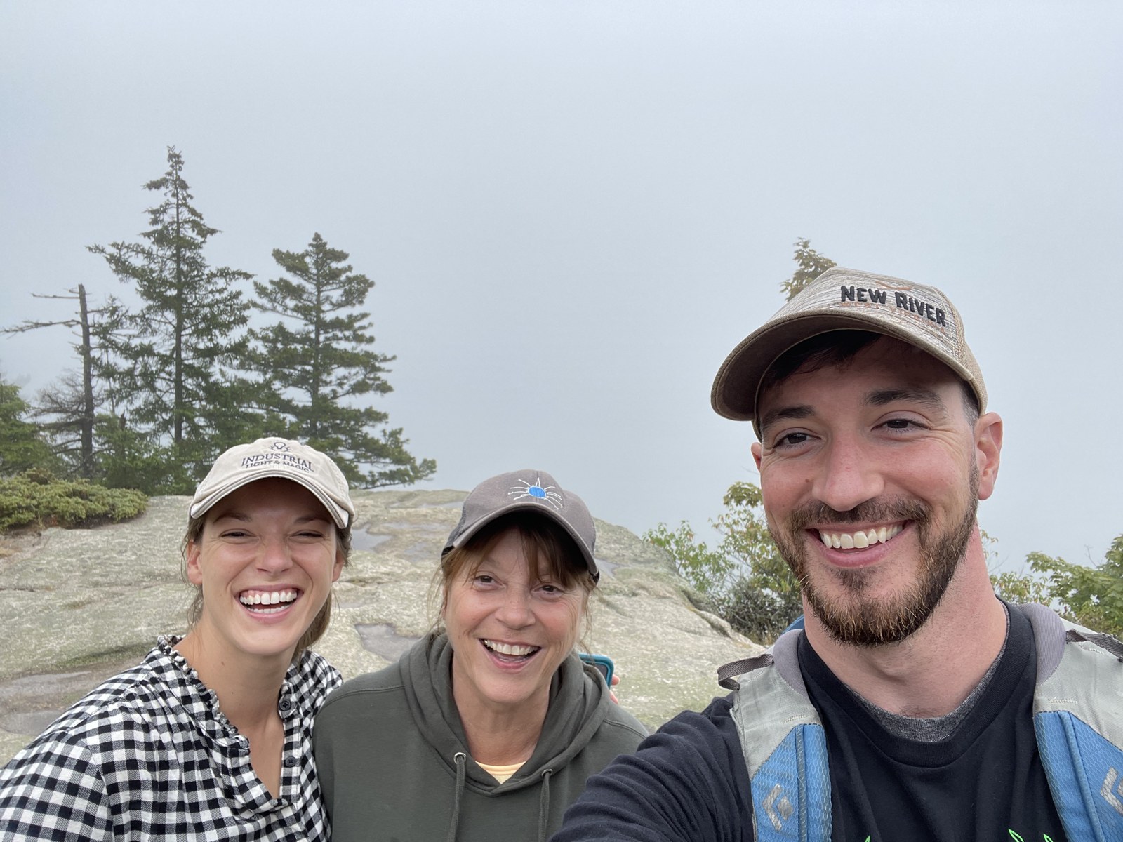 Brad Powell with two fellow hikers at a rocky overlook
