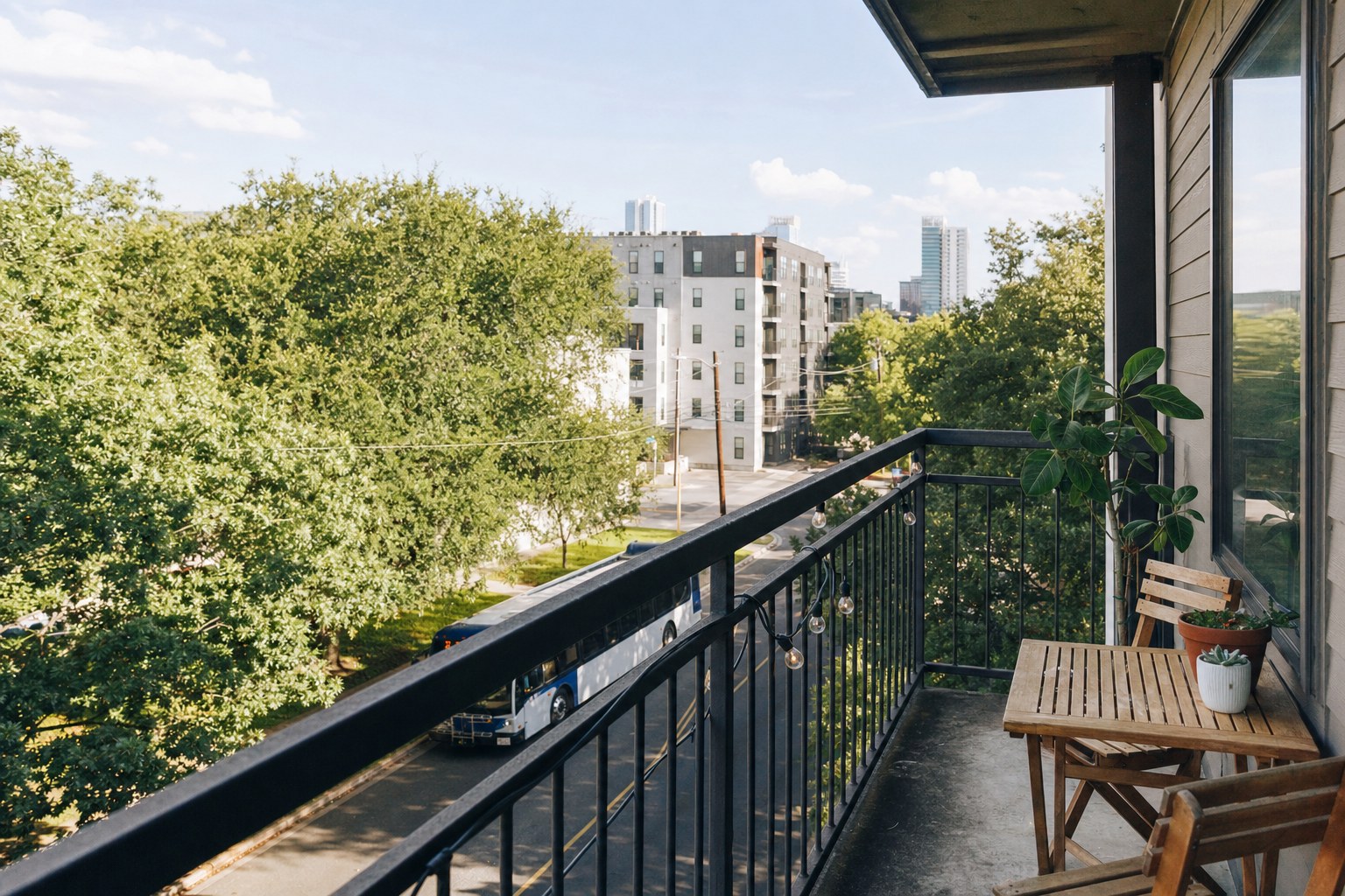 Apartment balcony overlooking an Austin street with a city bus