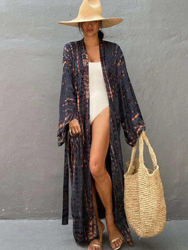 Long tie-dye kimono cover-up layered over a white swimsuit