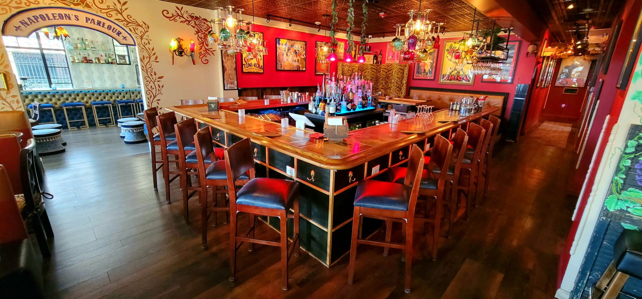 The bar interior at Vinos on Las Olas, with colorful lighting and the Napoleon’s Parlour arch
