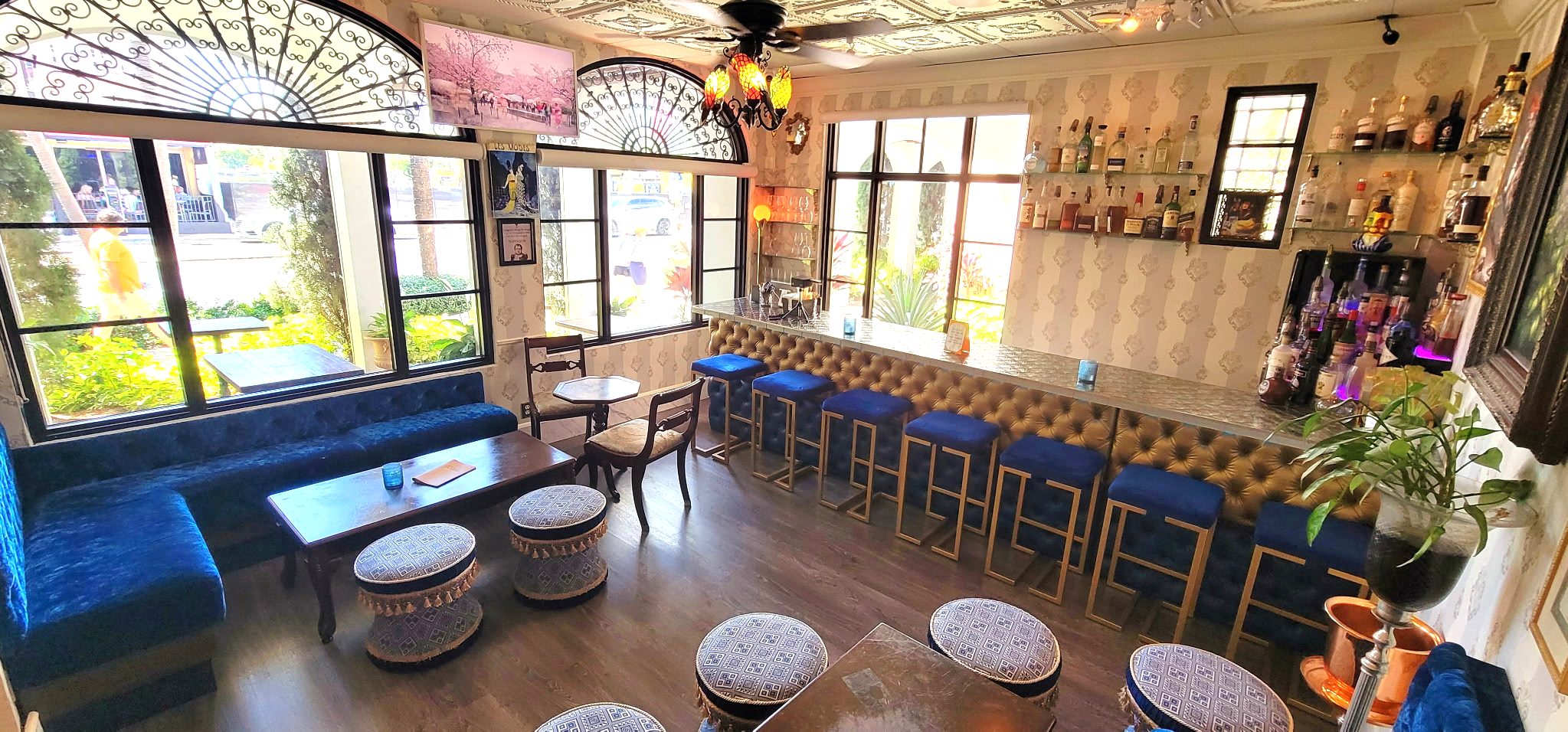 Blue velvet seating and the bar inside Napoleon’s Parlour at Vinos on Las Olas