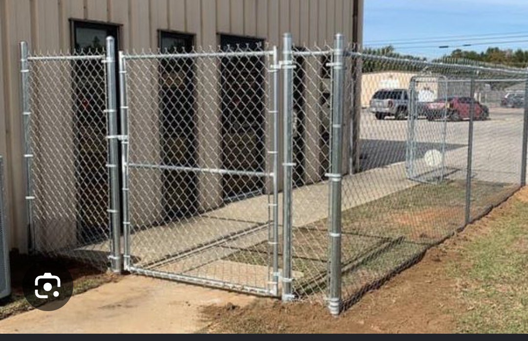 Chain-link walk gate beside a commercial building