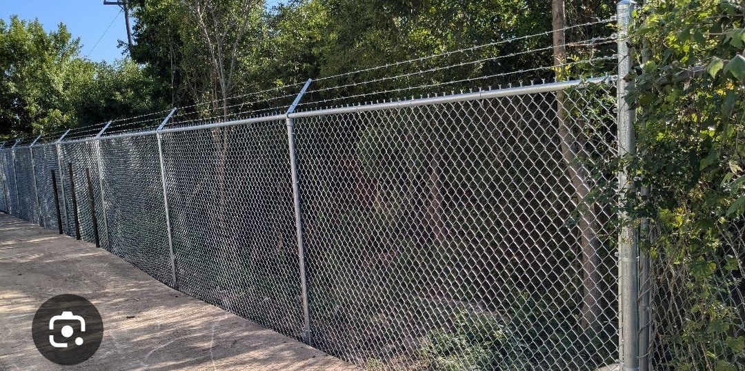 Chain-link perimeter fence with angled barbed-wire extensions