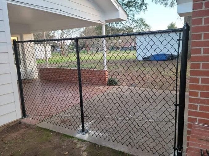 Black chain-link gate at a covered residential patio