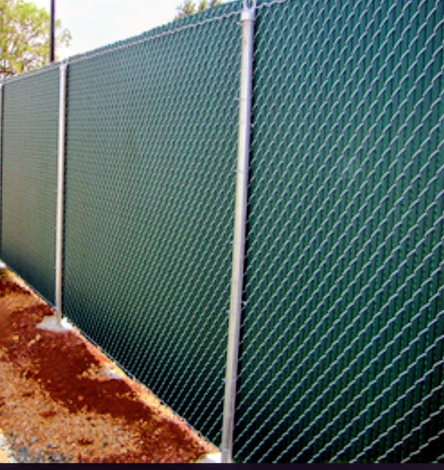 Chain-link fence with a green privacy screen