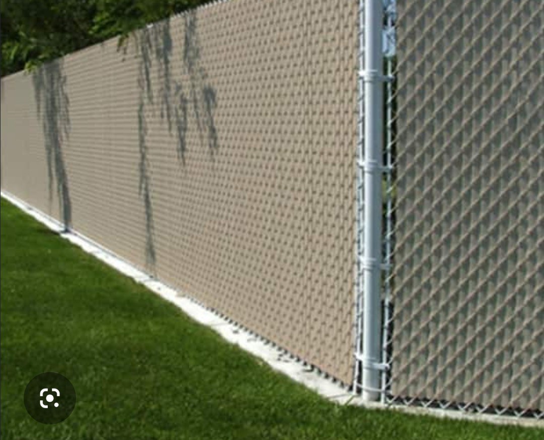 Chain-link fence with a tan privacy screen