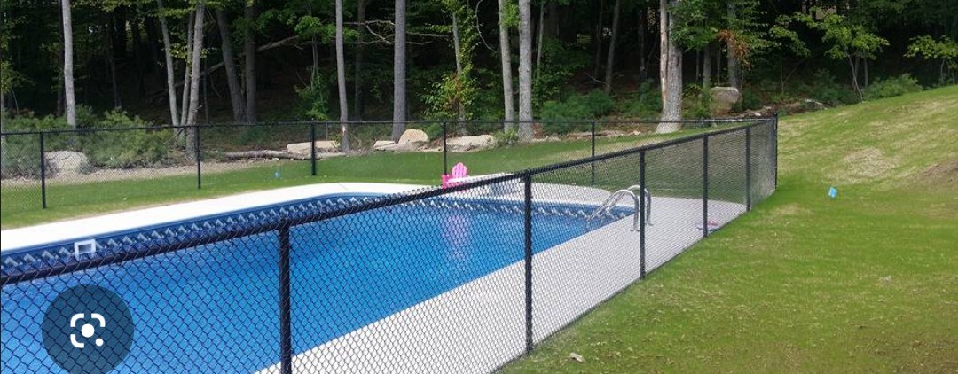 Black pool fence surrounding a residential pool