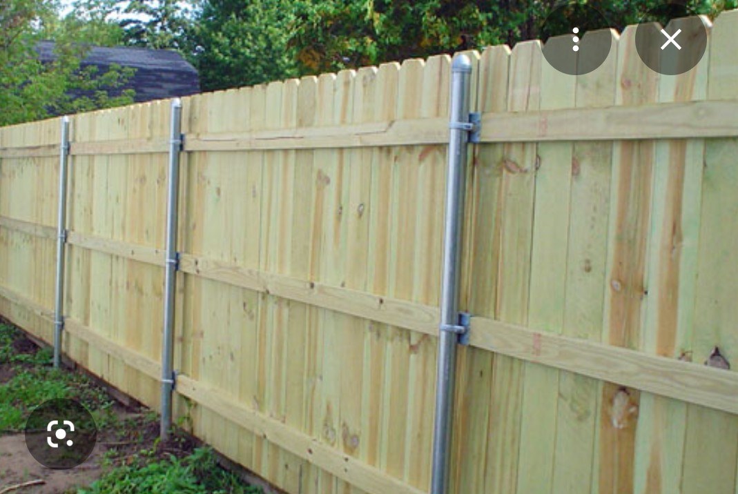 Finished wood fence and matching gate at a residential yard
