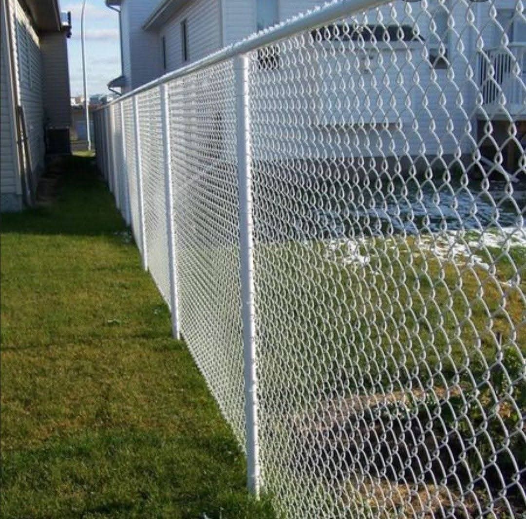 Chain-link fence running beside a house