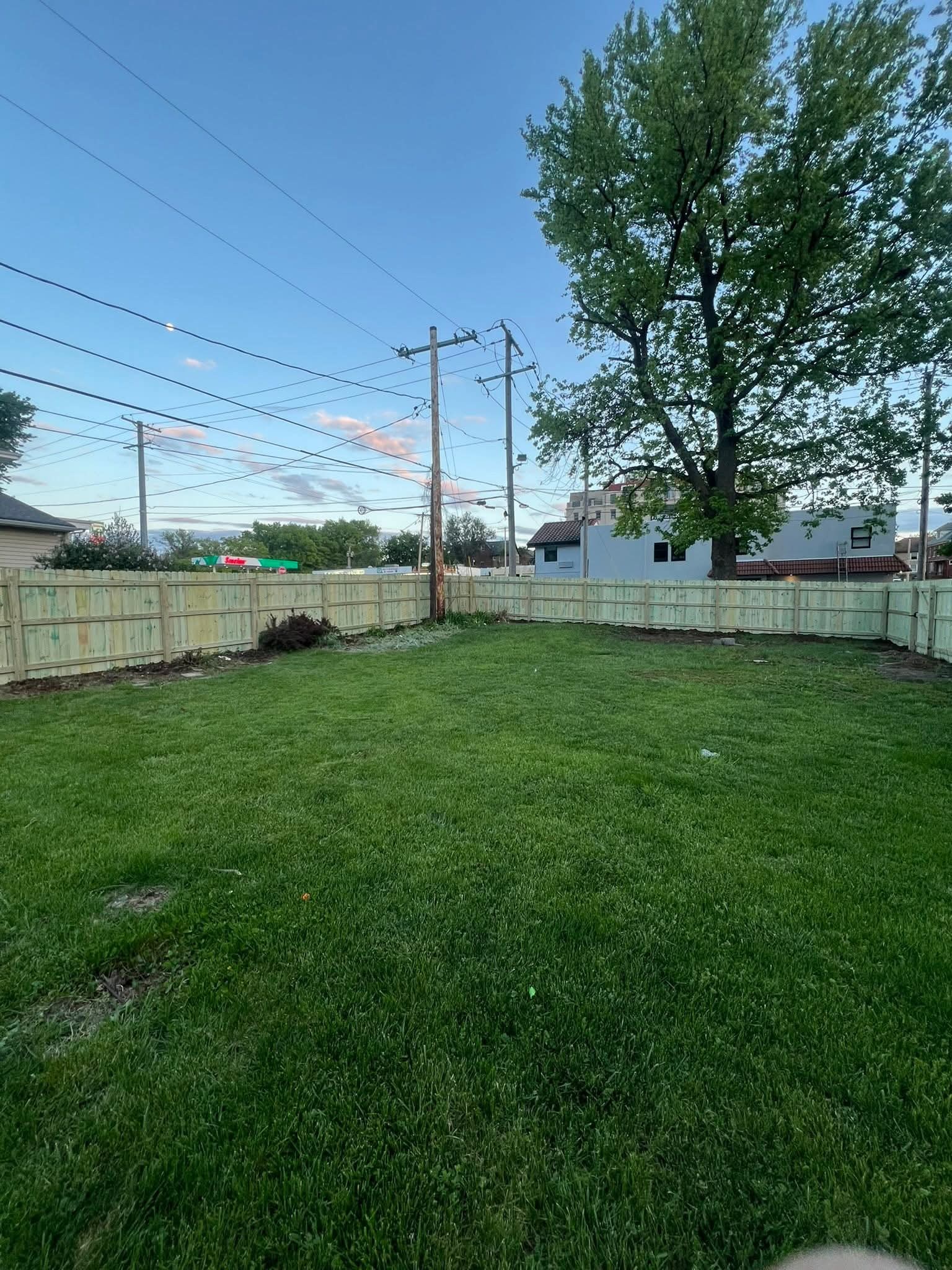 Wood privacy fence around a backyard perimeter
