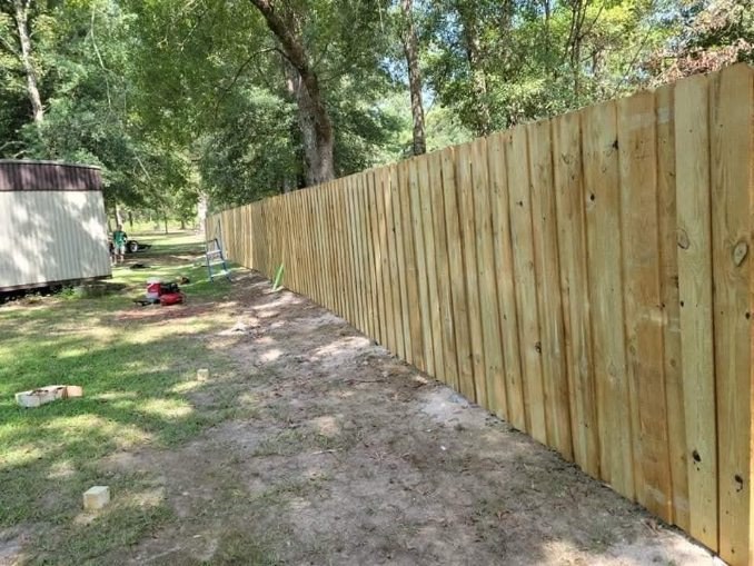 Long wood privacy fence along a backyard