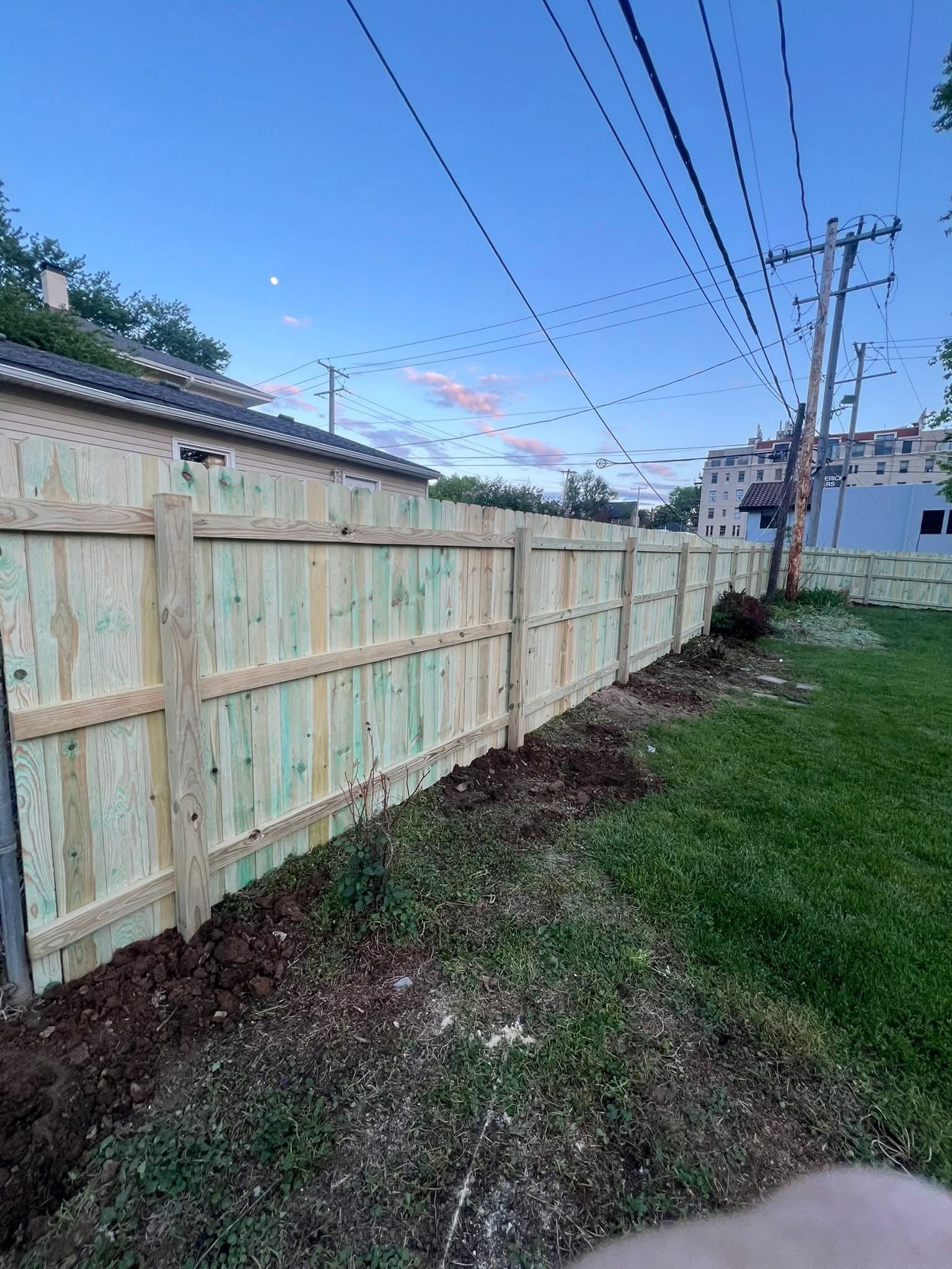 Long wood privacy fence beside a property