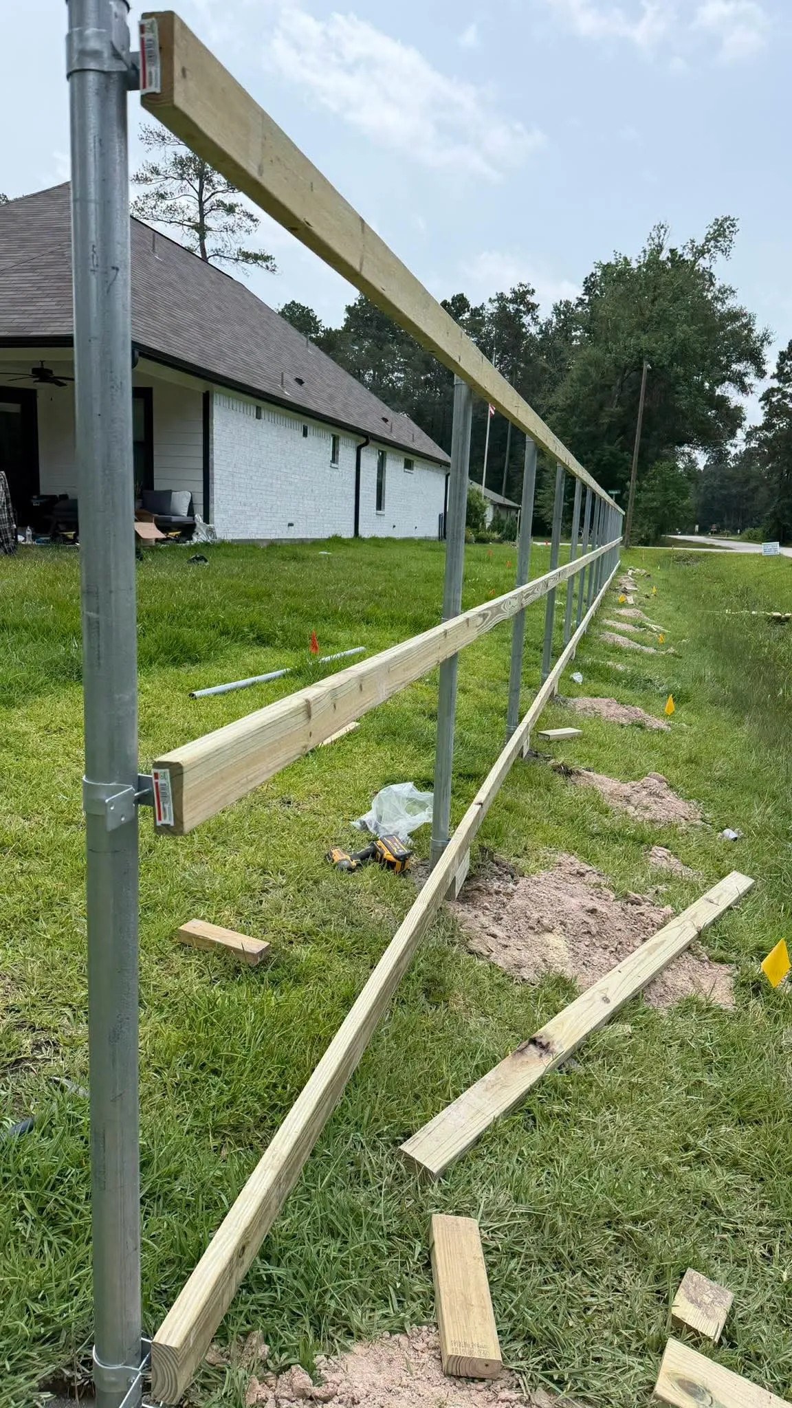 Wood rails installed on a new fence line