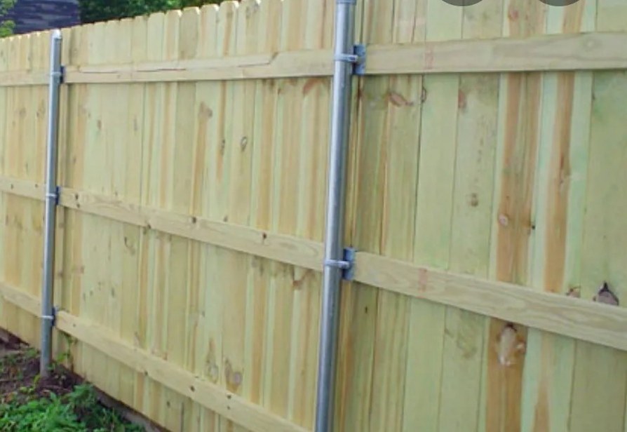 Wood privacy fence framed with steel posts