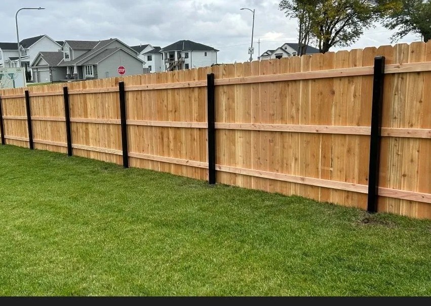 Wood privacy fence with black steel posts