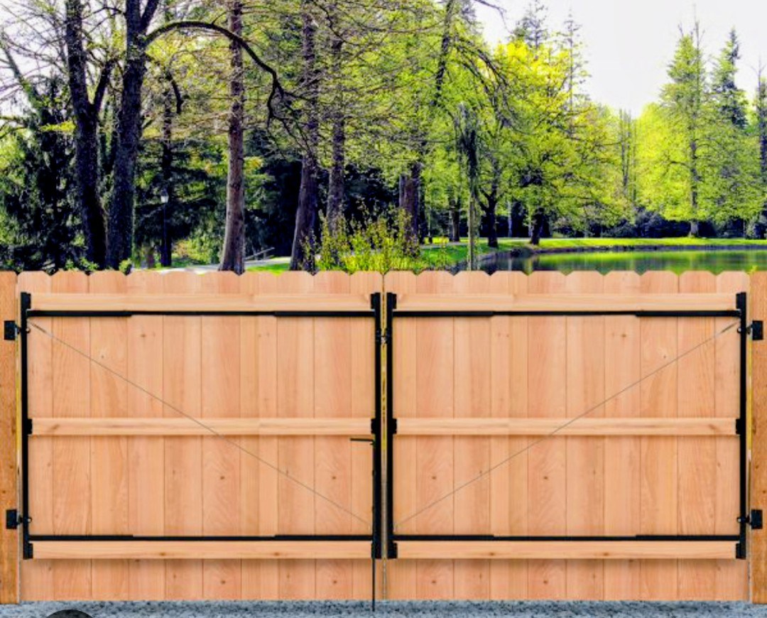Double wood driveway gate with black steel framing
