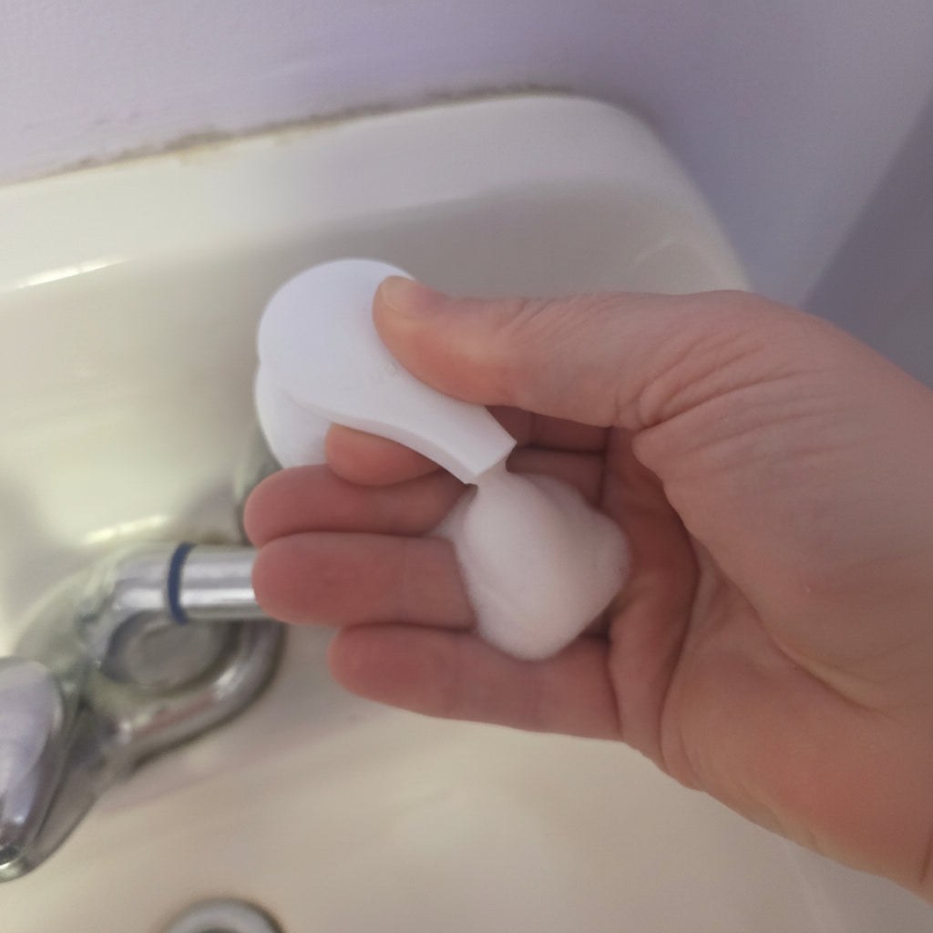 A Flickity Wick foaming hand soap bottle displayed at a sink