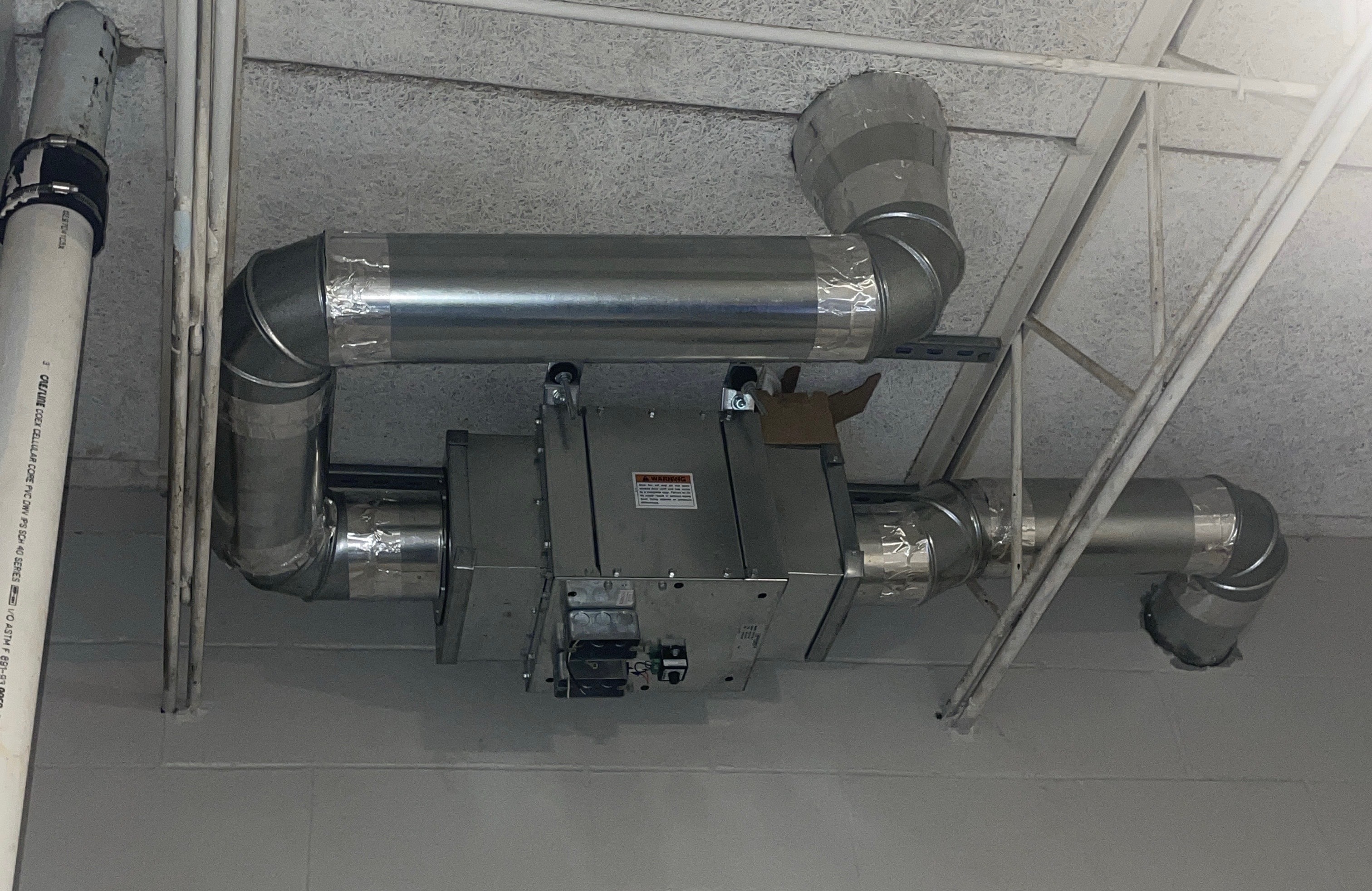 Commercial HVAC equipment and ductwork installed in a ceiling
