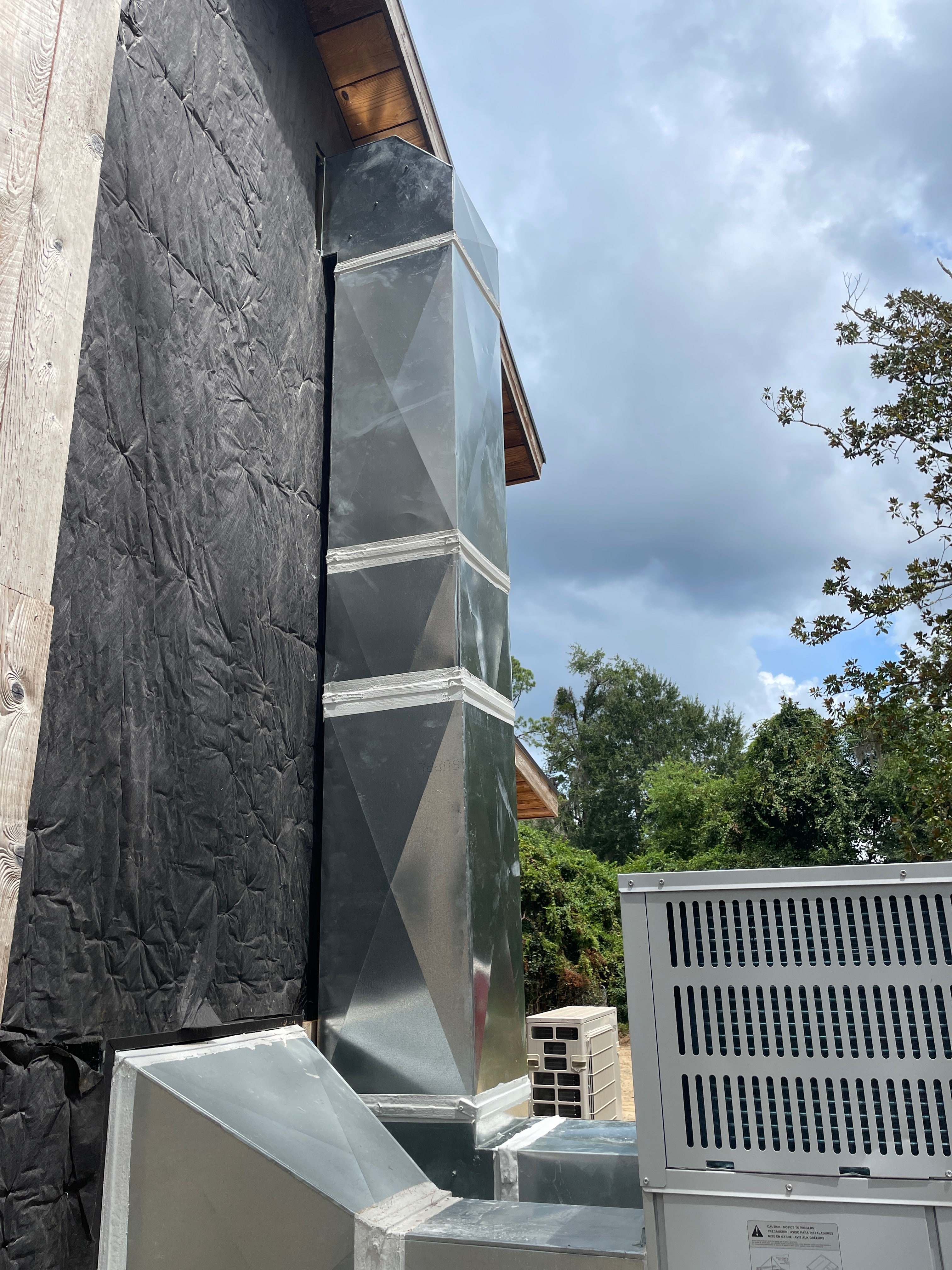 Exterior ductwork and outdoor HVAC equipment at a building