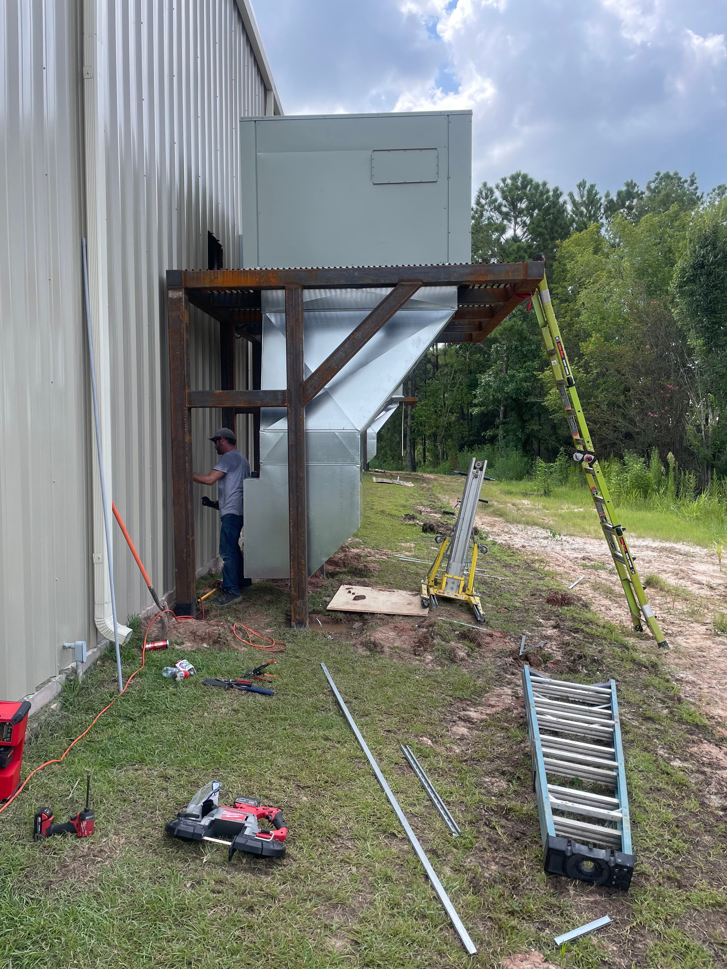 Outdoor HVAC equipment installation at a metal building