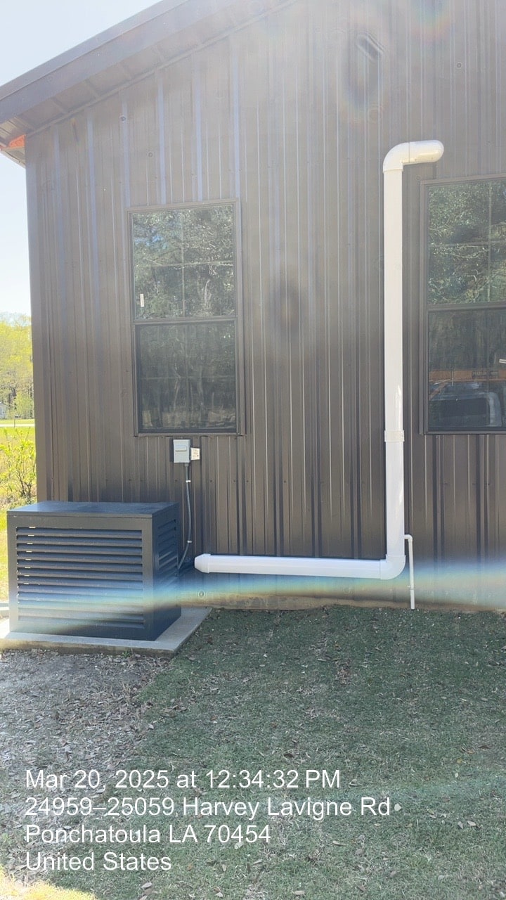 New mini-split outdoor unit installed beside a metal building