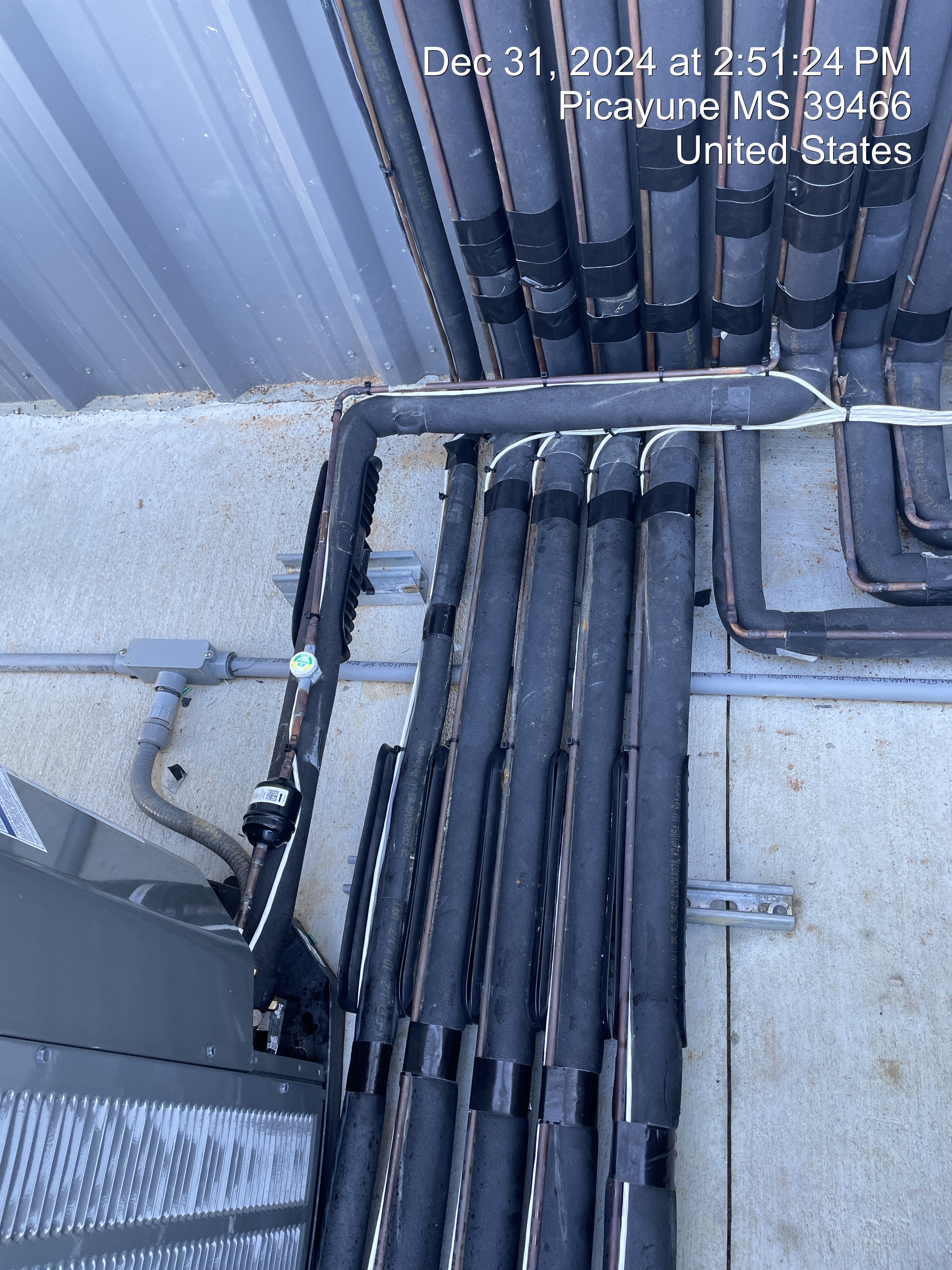 Organized electrical conduit feeding commercial HVAC equipment