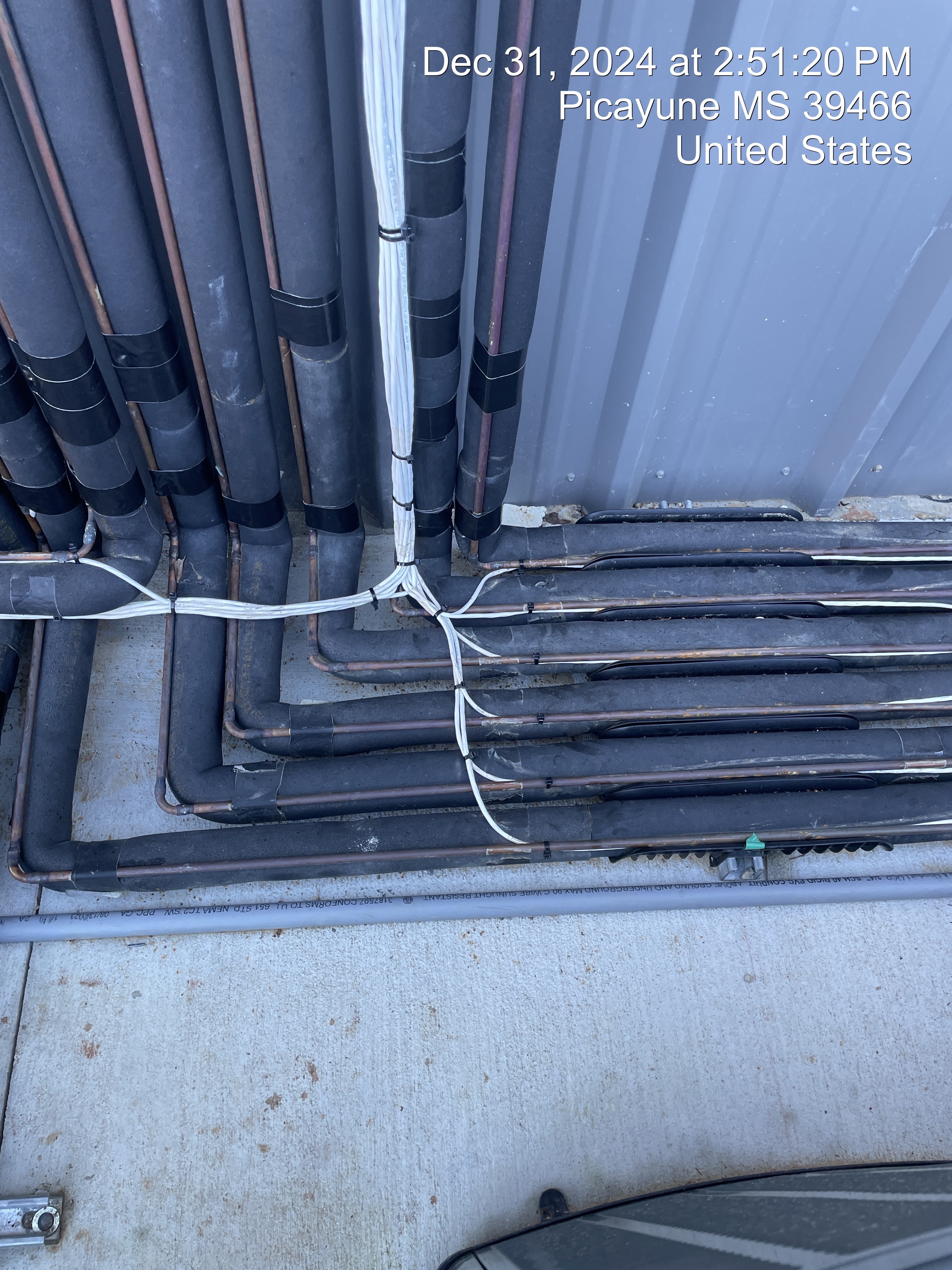 Commercial HVAC conduit installation along an exterior wall