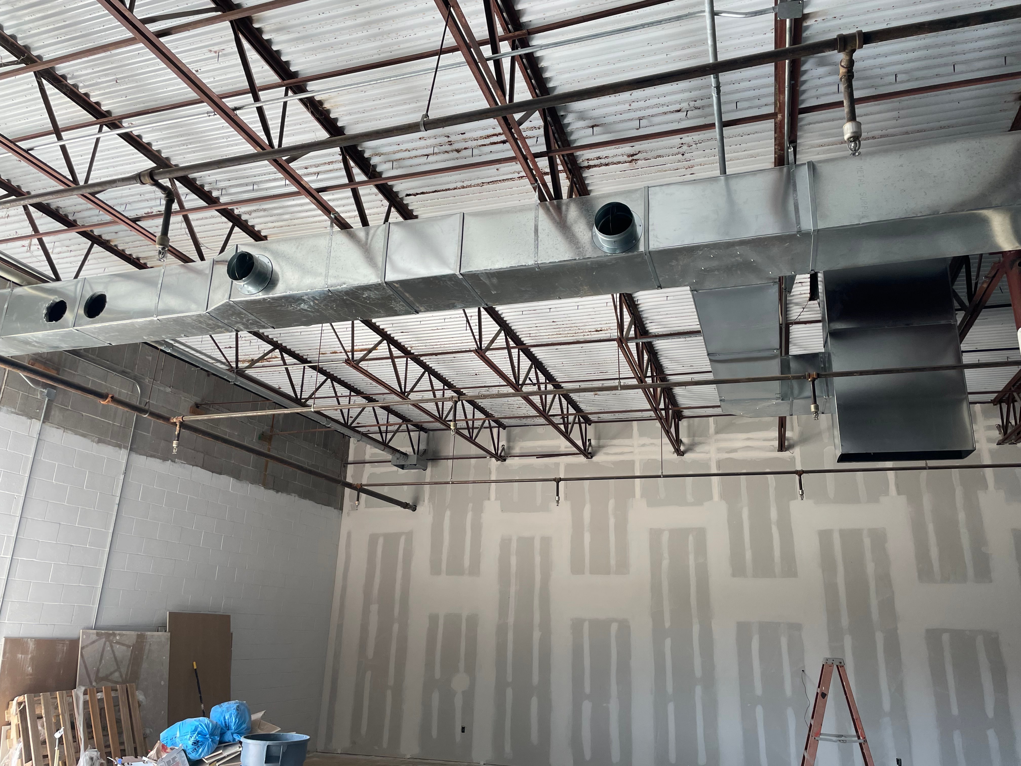 Exposed commercial ductwork installation inside a building