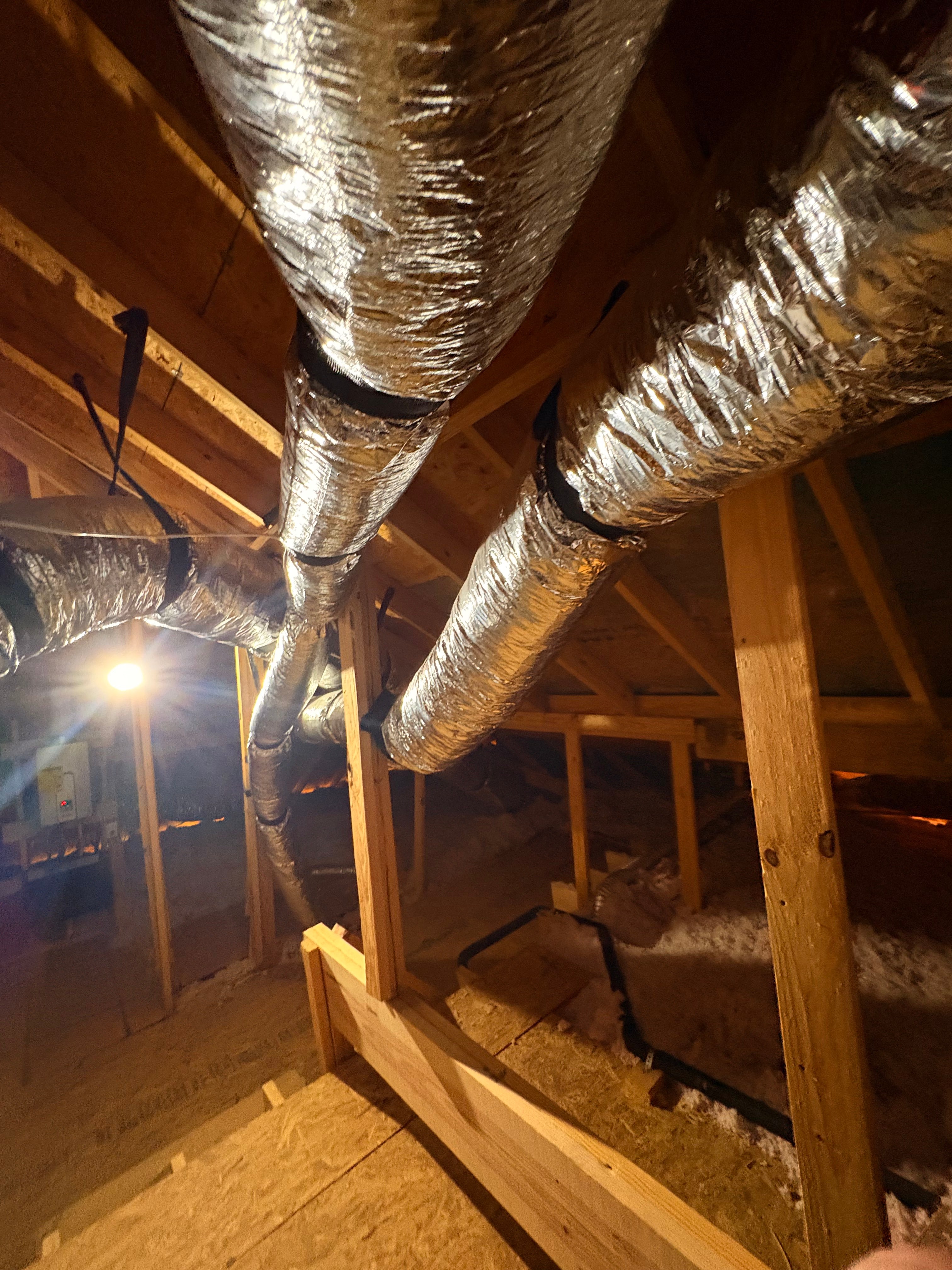 Residential attic with newly installed insulated ductwork