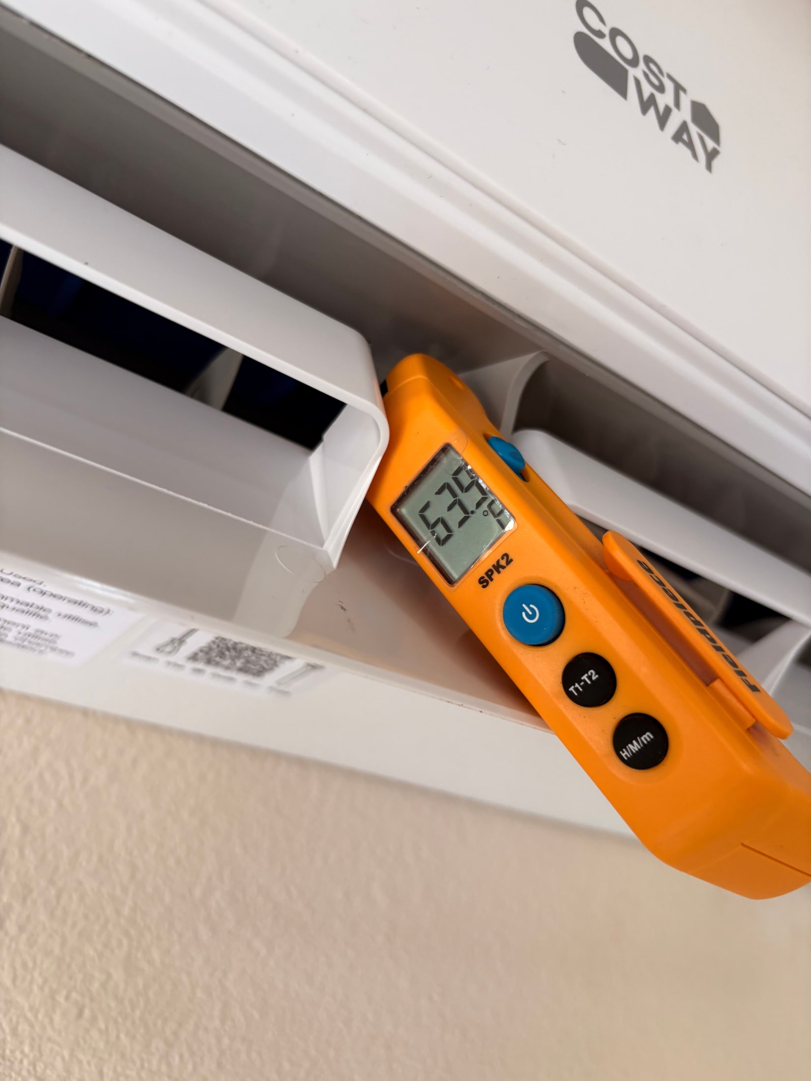Technician checking a ductless mini-split with a meter