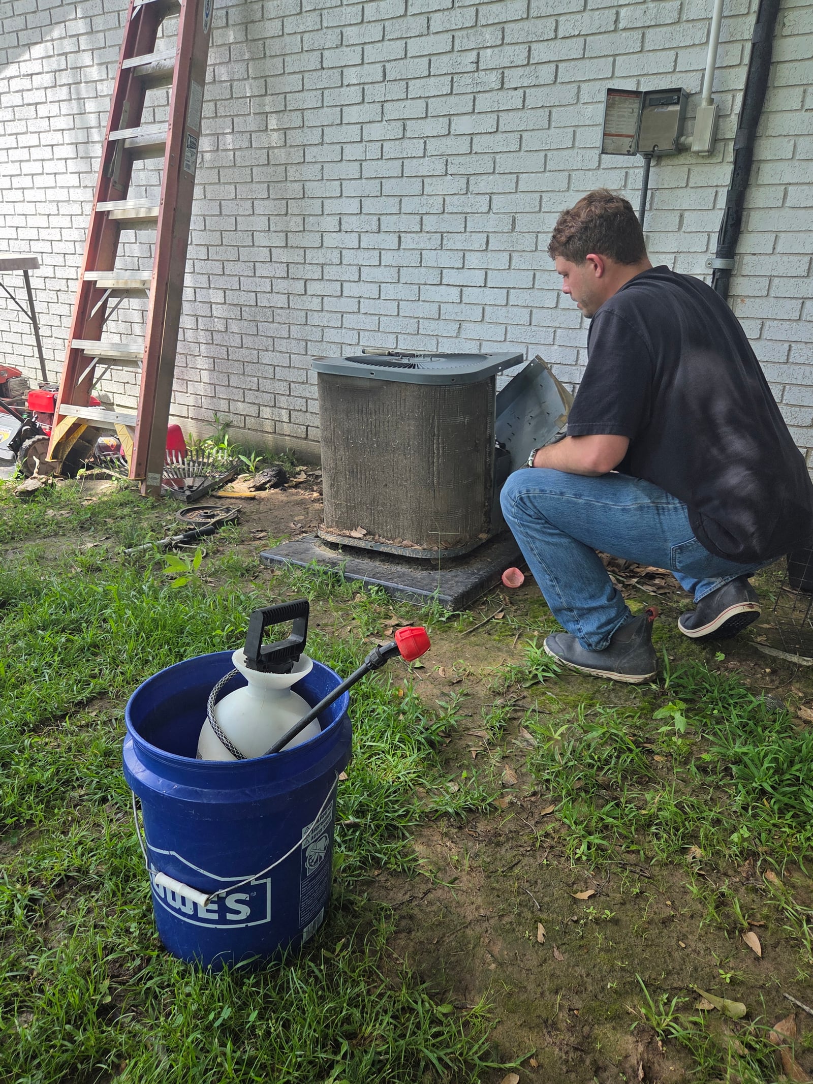 Technician testing an air-conditioning system during a diagnosis