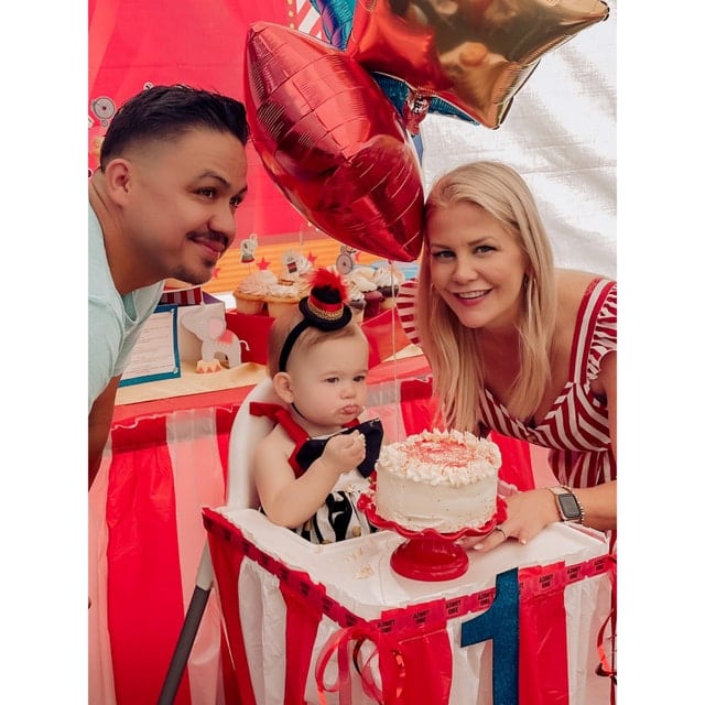 Child wearing a black and red ringmaster mini hat at a circus-themed birthday party