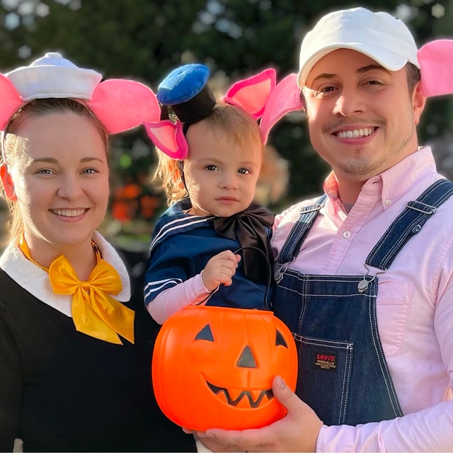 Family dressed as the Three Little Pigs for Halloween, including a child wearing a mini hat