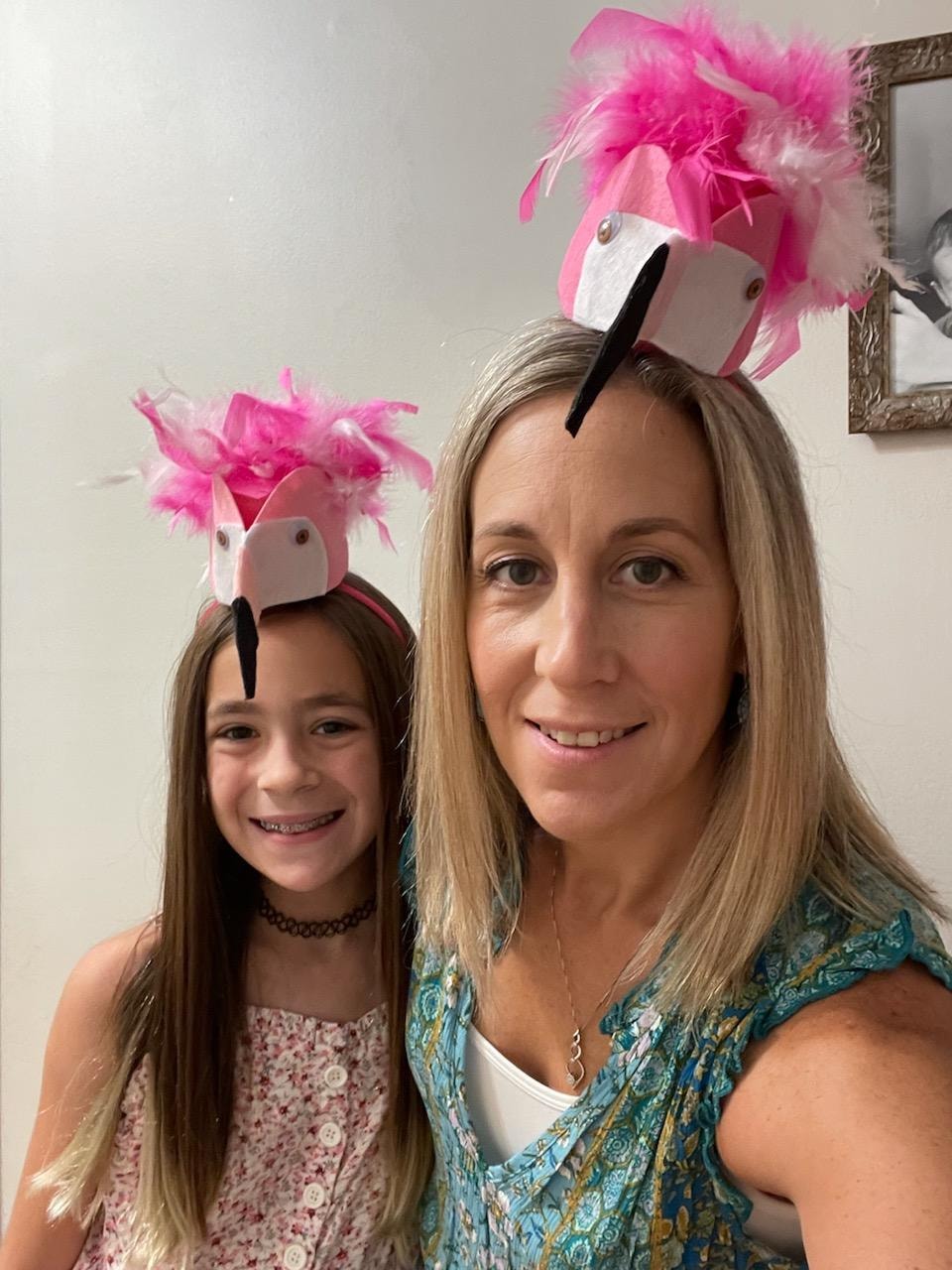 Shellie and her daughter wearing playful flamingo mini hats