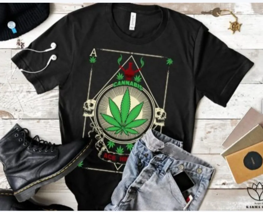 Black t-shirt with cannabis leaf design and text; 2 Sisters Tanks Teez and More