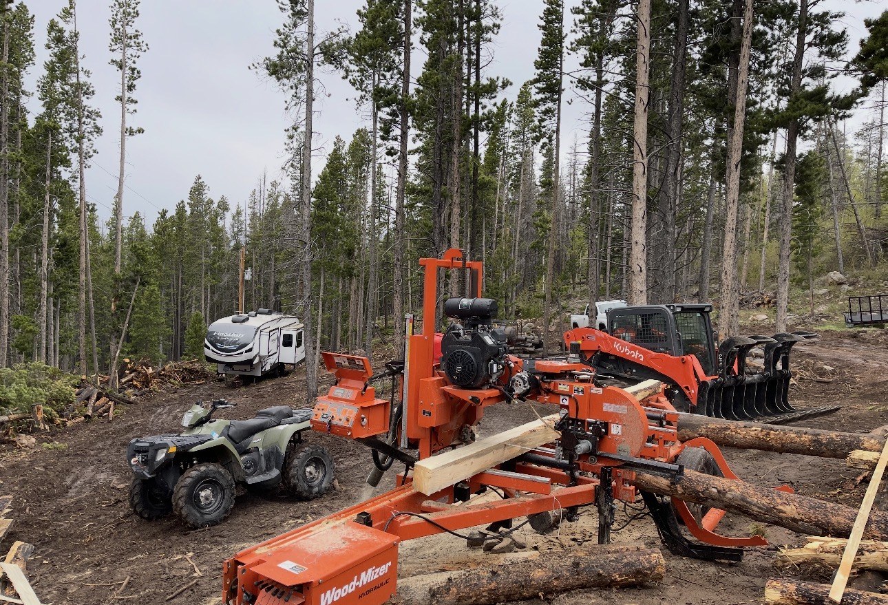 Portable sawmill milling beetle-kill pine in Colorado