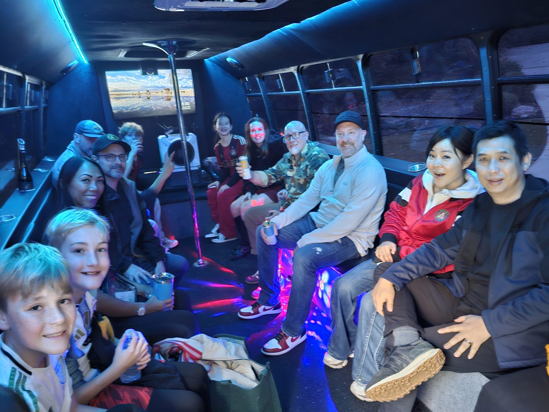 A group enjoying a sporting event outing with Kiwe’s Party Bus
