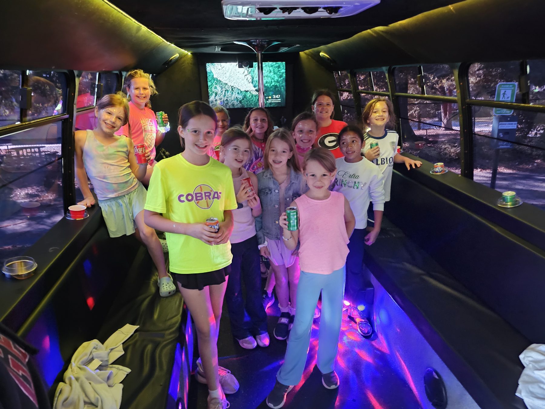 Kids celebrating together inside Kiwe’s Party Bus