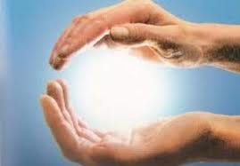 Hands held around a sphere of light
