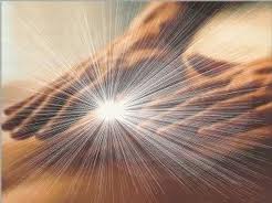Hands held together with radiant light