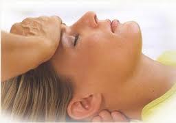 Gentle hands-near Reiki position at the forehead and back of the head