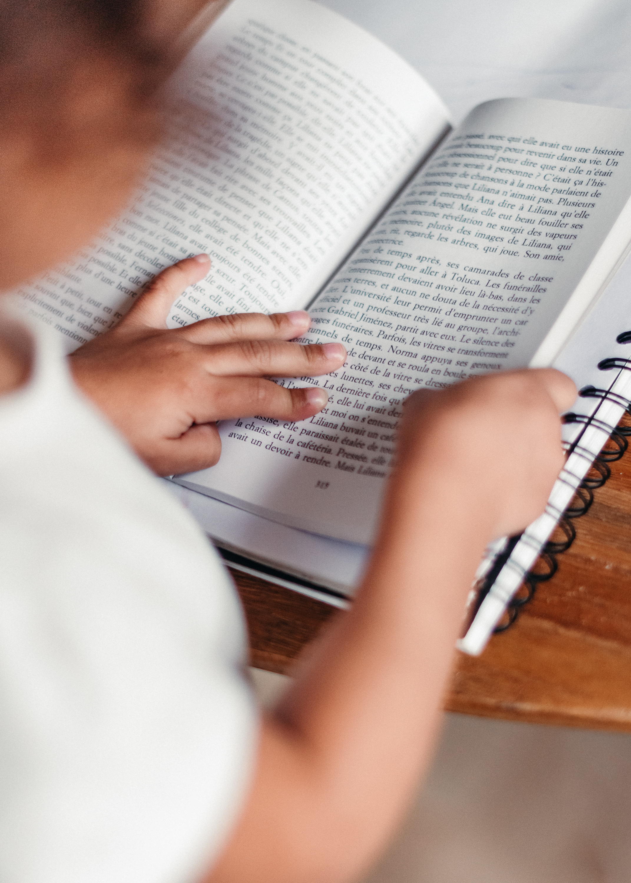 Child reading a book at home